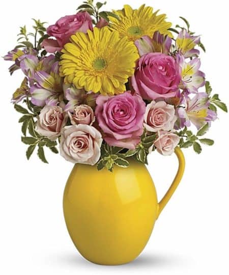 Pour on the charm with this delightfully sunny mix! Arranged in our signature Sunny Day pitcher - a lovely gift - this mix of bright gerberas and delicate roses is a guaranteed smile-getter.  