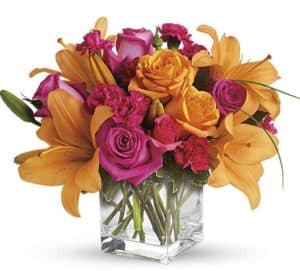 Send someone this vibrant mixture of opulent orange and zesty pink flowers casually arranged in a clear glass cube container. It a perfectly delightful way to express what's on your mind.