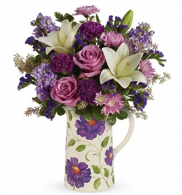 a luxurious mix of lavender roses and pure white lilies, hand-delivered in a charmingly rustic, Provencal style ceramic pitcher that's food safe for years of happy pouring!